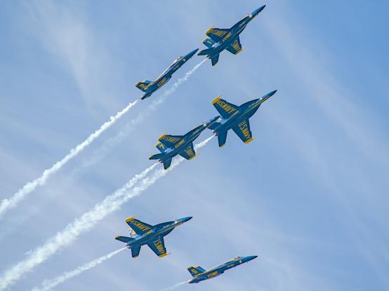 Blue Angel jets at an air show flying apart from a formation